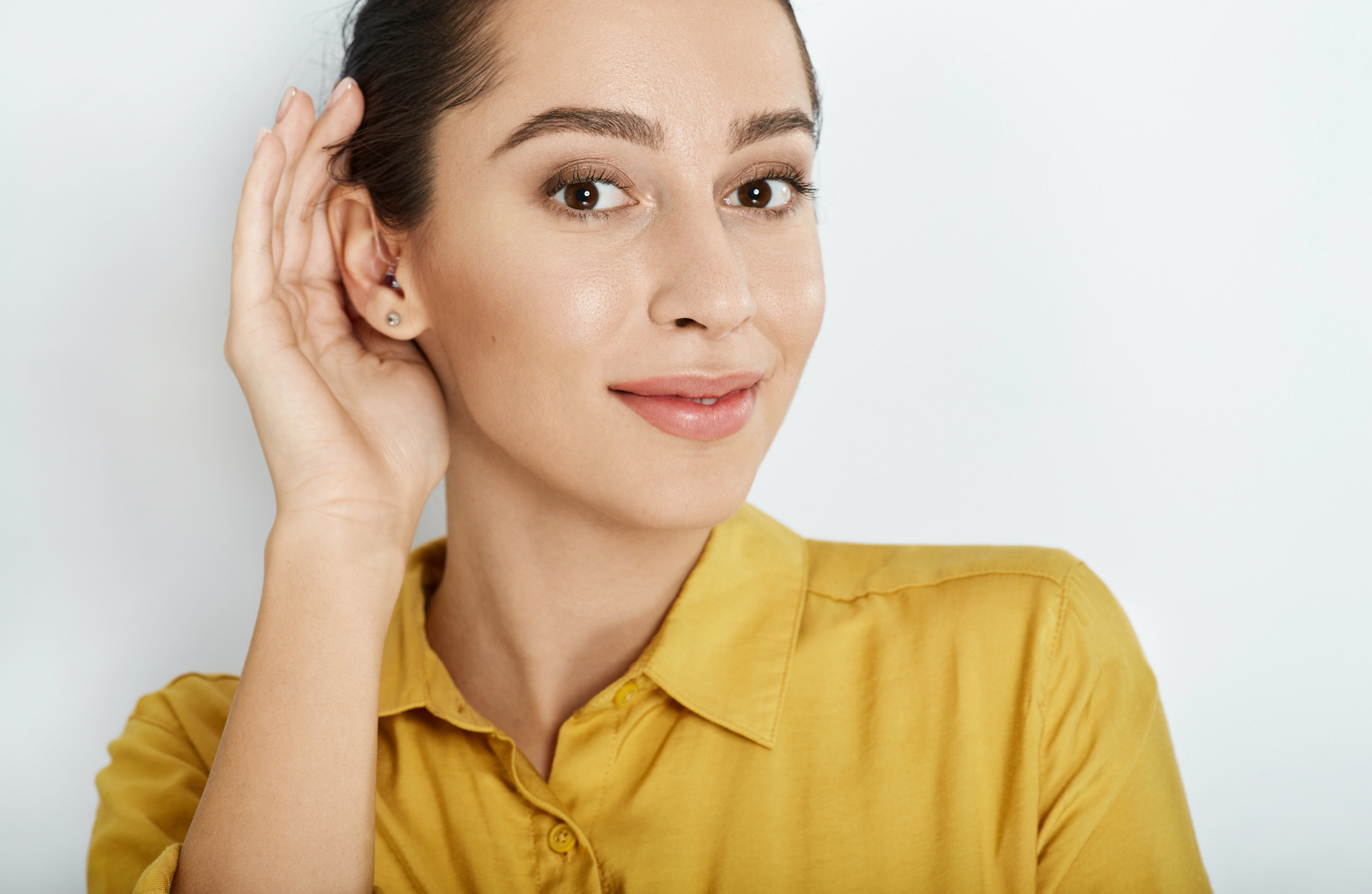 Listening woman with hand near ear for hearing check-up. Hearing test concept